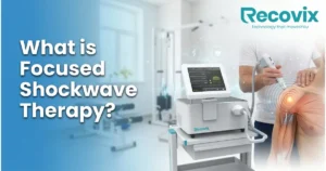 Focused shockwave therapy machine treating a patient for chronic musculoskeletal pain in a modern physiotherapy rehabilitation clinic